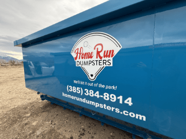 Home Run Dumpsters branded blue roll-off dumpster